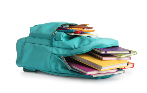 Turquoise backpack with different school supplies isolated on white - Фото, изображение