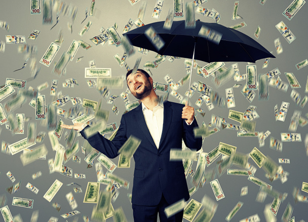 άτομο που στέκεται κάτω από βροχή χρήματα - Φωτογραφία, εικόνα