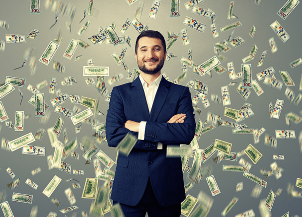 uomo d'affari sorridente sotto la pioggia del dollaro
 - Foto, immagini