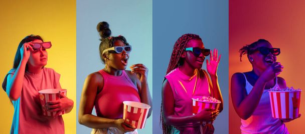 Four young women with popcorn isolated over colored backgrounds in neon lights. Flyer - Foto, immagini