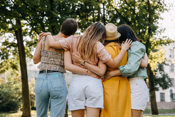 Group of four women outdoors, having good time, hugging. - Fotografie, Obrázek
