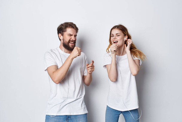 mies ja nainen valkoisissa t-paidoissa seisovat ystävyyden vieressä hauskaa valoa tausta - Valokuva, kuva