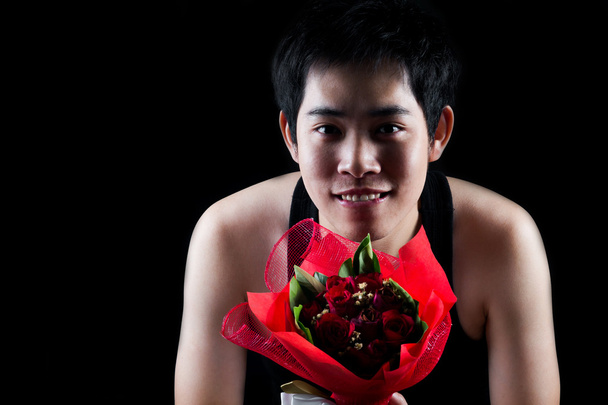 Asiatique garçon avec rouge bouquet dans sombre fond
 - Photo, image