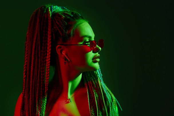 young woman with dreadlocks in red sunglasses - Фото, изображение