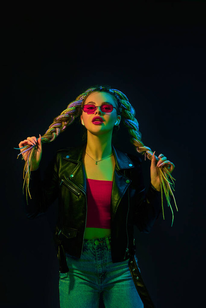 young woman with dreadlocks in red sunglasses dancing - Фото, зображення