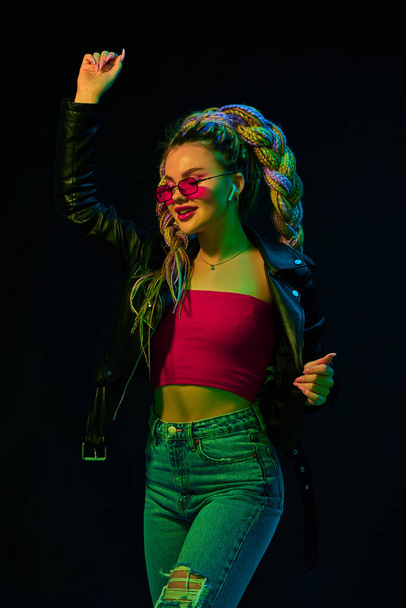 young woman with dreadlocks in red sunglasses dancing - Fotoğraf, Görsel