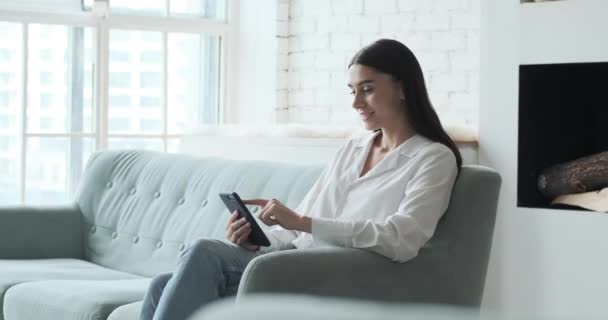 Sorridente giovane donna godendo utilizzando l'applicazione smartphone leggendo notizie positive - Filmati, video