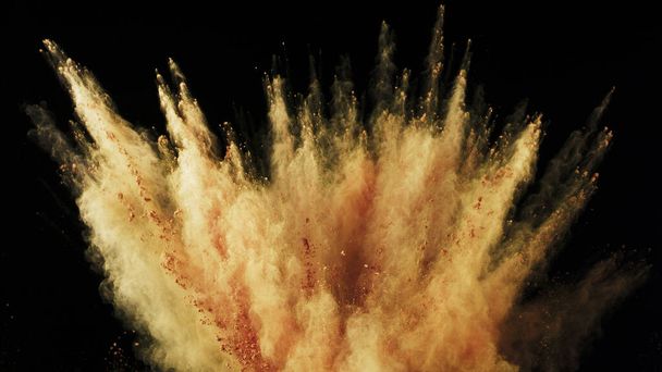 Freeze motion of coloured powder explosion. Isolated on black background. - 写真・画像