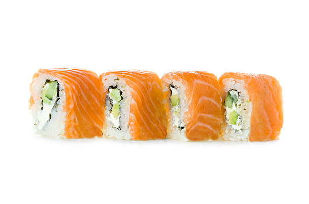 Sushi on a white background. Philadelphia classic. Maki. Salmon, Philadelphia cheese, cucumber, avocado. - Photo, Image