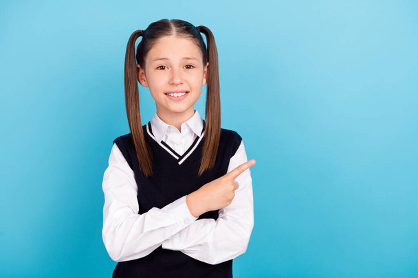 Photo of funny small brunet girl point empty space wear white shirt vest isolated on blue color background. - Φωτογραφία, εικόνα