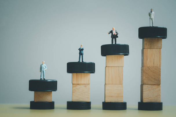 Miniature people businessmen standing on wooden block of bar graph with performance as background strategy concept and Business concept with copy space. - Fotoğraf, Görsel
