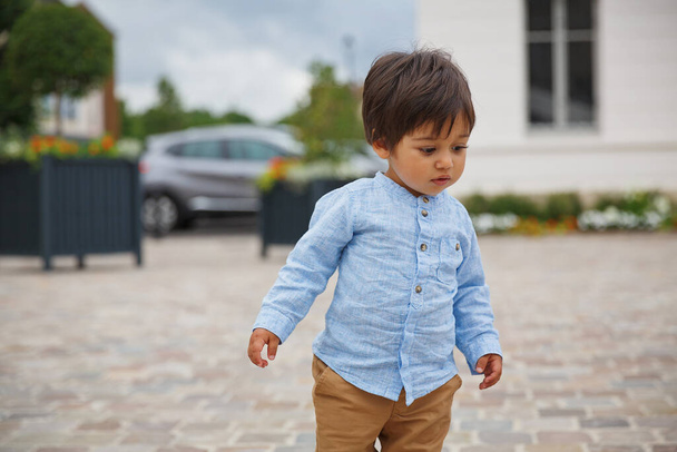 Portrait of a little eastern handsome baby boy playing outdoor in the park - Foto, imagen