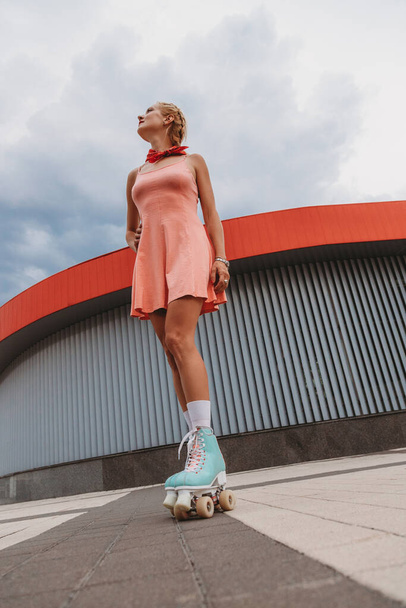 Stylish young woman with vintage roller skates outdoor - Фото, зображення