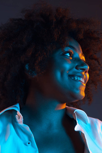 Emotive girl. Close-up portrait of African young woman isolated on dark blue studio background. Concept of human emotions, facial expression, youth, diversity, ad. - Photo, Image