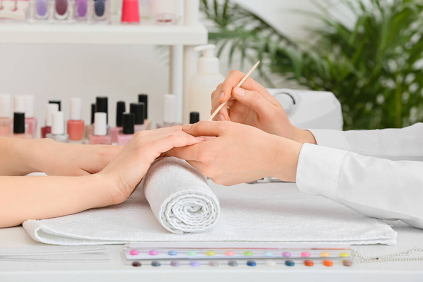 Manicure master working with female client in beauty salon - Fotografie, Obrázek