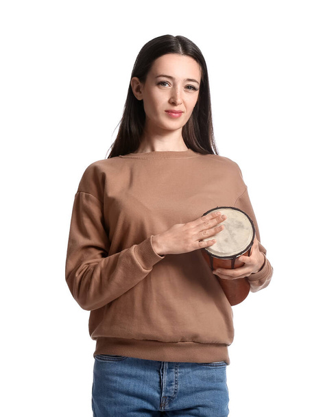 Young woman with tam-tam on white background - Φωτογραφία, εικόνα