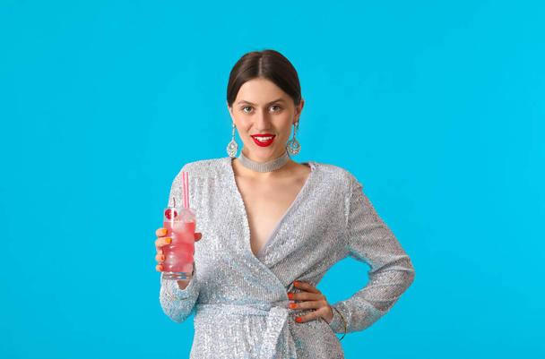 Beautiful young woman with cocktail on color background - Photo, Image