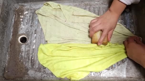 hand of a woman soaping some cleaning rags in a laundry room - Footage, Video