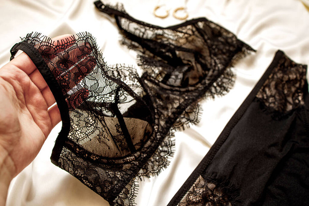 Lace underwear on a beige silk, top view. Fashion concept. - Foto, Imagem