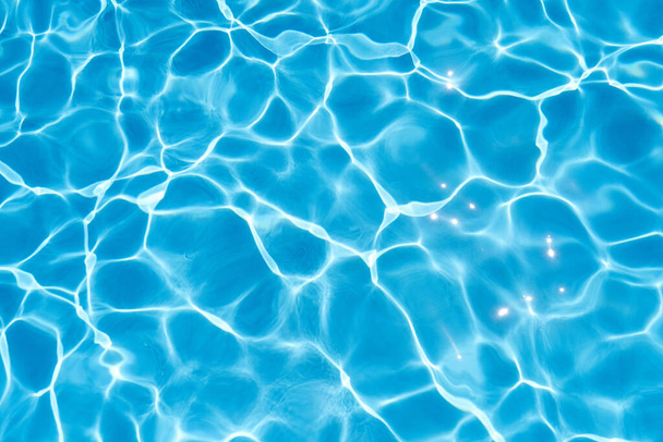 Sun rays are reflected in the blue water of the pool. Close-up - Photo, Image