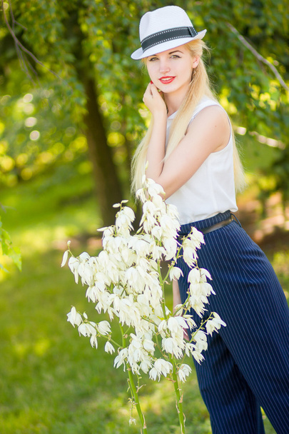 Outdoor summer portrait of young pretty cute blonde girl. Beautiful woman posing in the park - Photo, Image