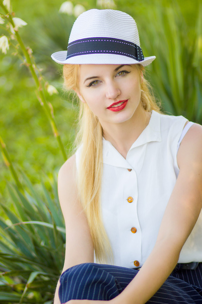 Outdoor summer portrait of young pretty cute blonde girl. Beautiful woman posing in the park - Foto, Imagem