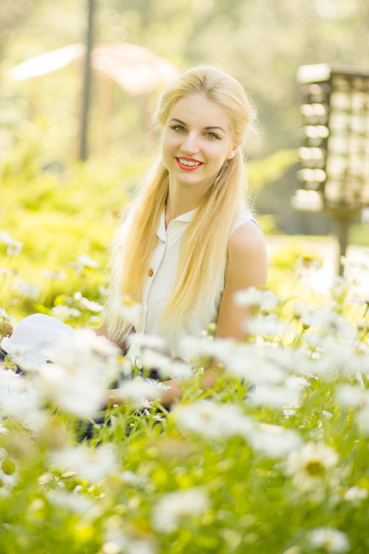 Outdoor summer portrait of young pretty cute blonde girl. Beautiful woman posing in the park - Foto, afbeelding