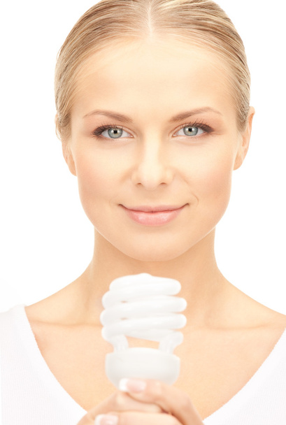 Bright picture of woman holding energy saving bulb - Фото, изображение