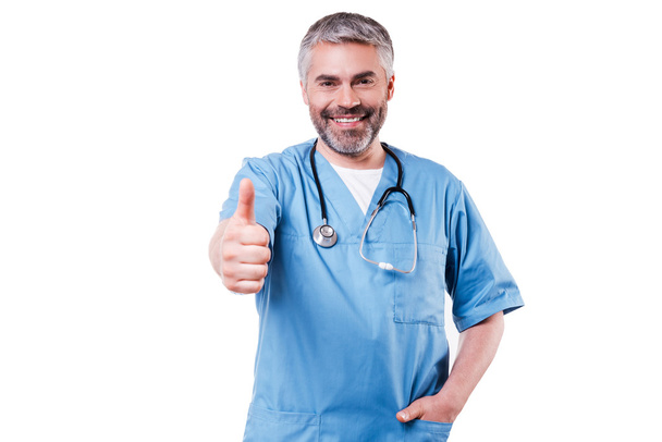 Surgeon in blue uniform showing thumb up - Photo, image