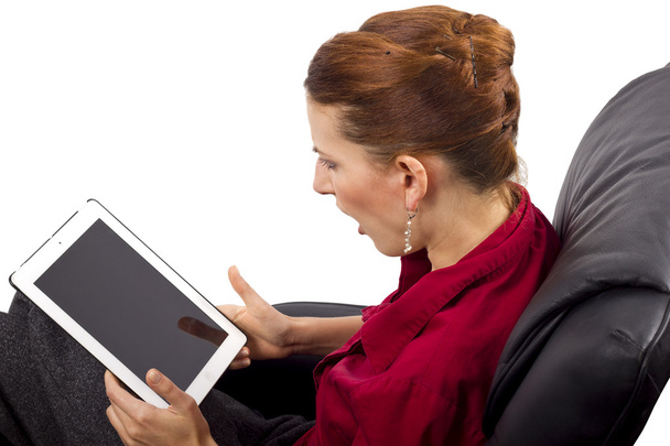 Woman looking at tablet computer - Fotó, kép