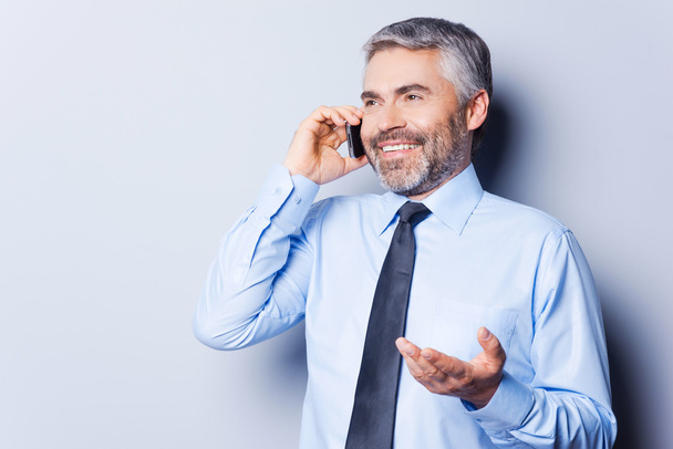 Man in shirt and tie talking on mobile phone - Photo, image