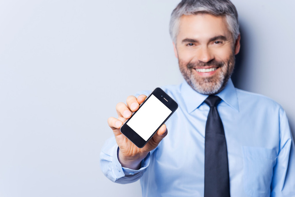 Happy businessman with mobile phone. - Photo, Image