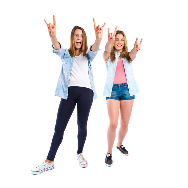 Friends making horn gesture over white background - Photo, Image