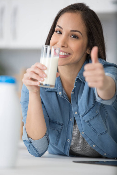 smiling woman holding milk bottle - 写真・画像
