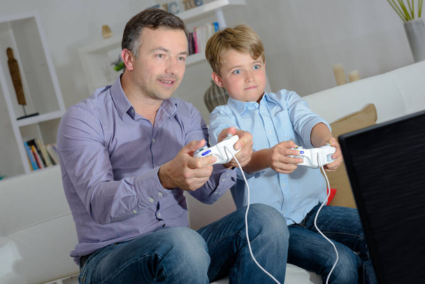 Father and son engrossed in a computer game - Fotografie, Obrázek