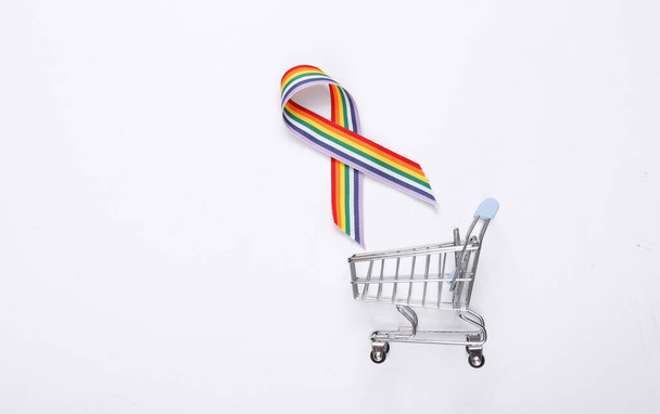 LGBTレインボーリボンプライドテープシンボルと白い背景のショッピングトロリー. - 写真・画像