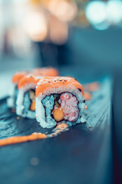 spicy salmon sushi roll close up - Fotó, kép