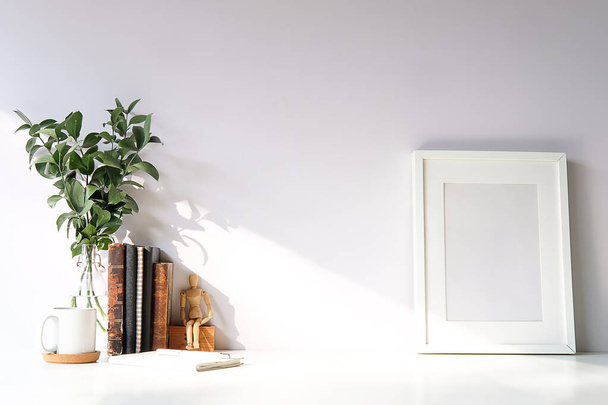 Schreibtisch-Attrappe und Bücher zum Kopieren, Pflanzen und Kaffee auf weißem Schreibtisch - Foto, Bild