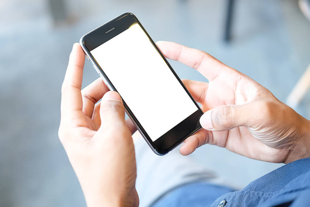 Przycięty widok na ręce człowieka trzymające smartfon z pustym ekranem miejsca do kopiowania wiadomości tekstowych lub treści informacyjnych, kobiece czytanie wiadomości tekstowych w telefonie komórkowym podczas miejskiego ustawienia.  - Zdjęcie, obraz