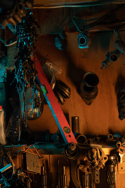 A lot of old rusty instruments in vintage dirty garage. High quality photo - Φωτογραφία, εικόνα