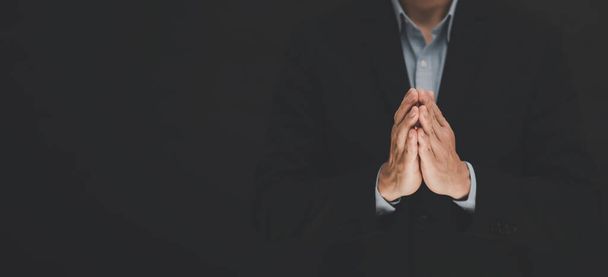businessman hand praying and worship to GOD Using hands to pray in religious beliefs and worship christian in the church or in general locations in vintage black tone or copy space. - Photo, Image