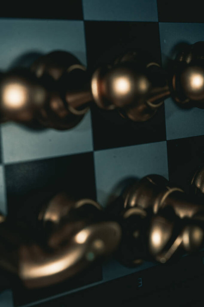 A vertical closeup shot of chessmen on a chessboard - Фото, изображение