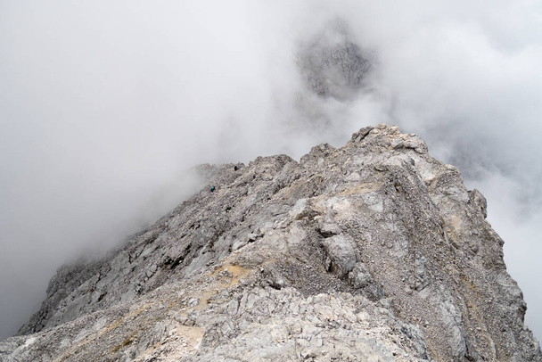 A misty day at Zugspitze in Austria, Germany with clouds covering the peak - Foto, immagini