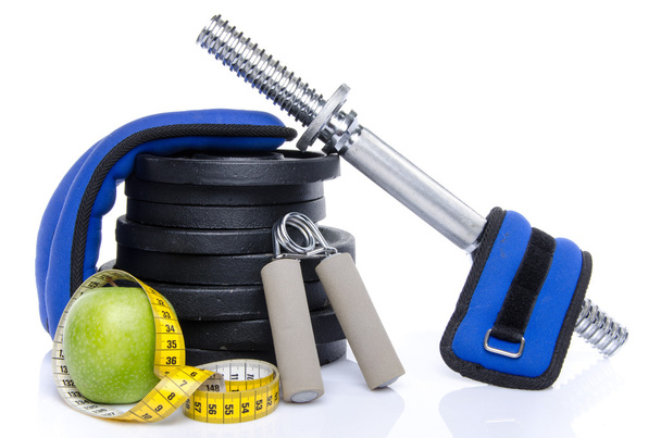 Health concept, an apple with a tape measure and fitness equipme - Photo, Image