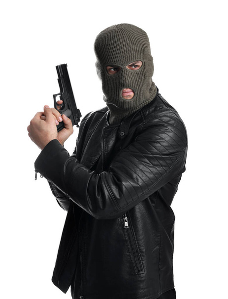 Man wearing knitted balaclava with gun on white background - Photo, image