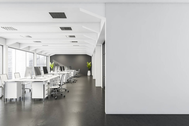 Blank partition with office space, having desks with rolling chairs, two plants, panoramic view and dark grey wall with concrete flooring. A concept of modern interior design. 3d rendering - Foto, afbeelding