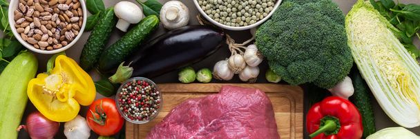 Fresh farm organic vegetables banner, healthy food concept, vegetables and mushrooms, superfoods and beans around the board with a large fresh piece of beef fillet, top view - Fotoğraf, Görsel
