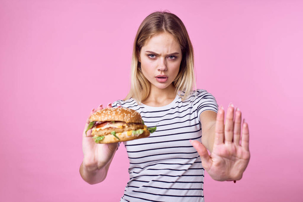 cute blonde girl in striped t-shirt hamburger close-up fast food lifestyle - Photo, image