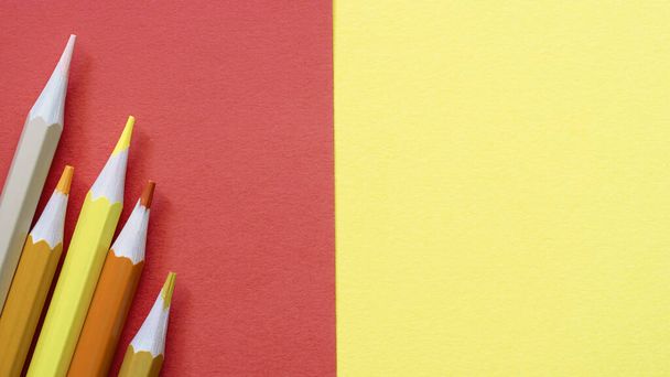 Олівці на порожньому аркуші, червоному і жовтому тлі. Високоякісна фотографія
 - Фото, зображення