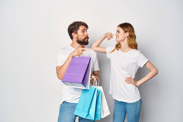 man and woman multicolored shopping bags shopping sale entertainment - Foto, afbeelding
